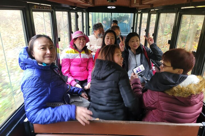 Lively conversations and shared smiles fill the air as travelers embark on an unforgettable journey through East Jeju Island exploring its stunning landscapes and rich cultural heritage.